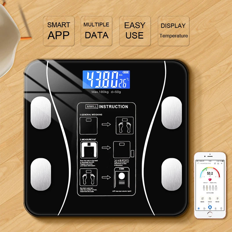 Digital body fat scale with smartphone app on wooden surface