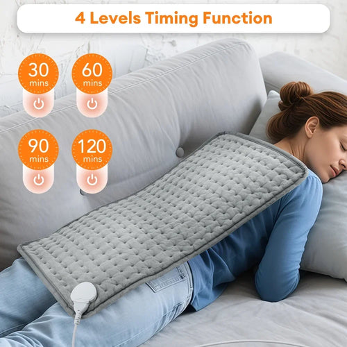 Woman using a heating pad with 4-level timing function display on a couch.