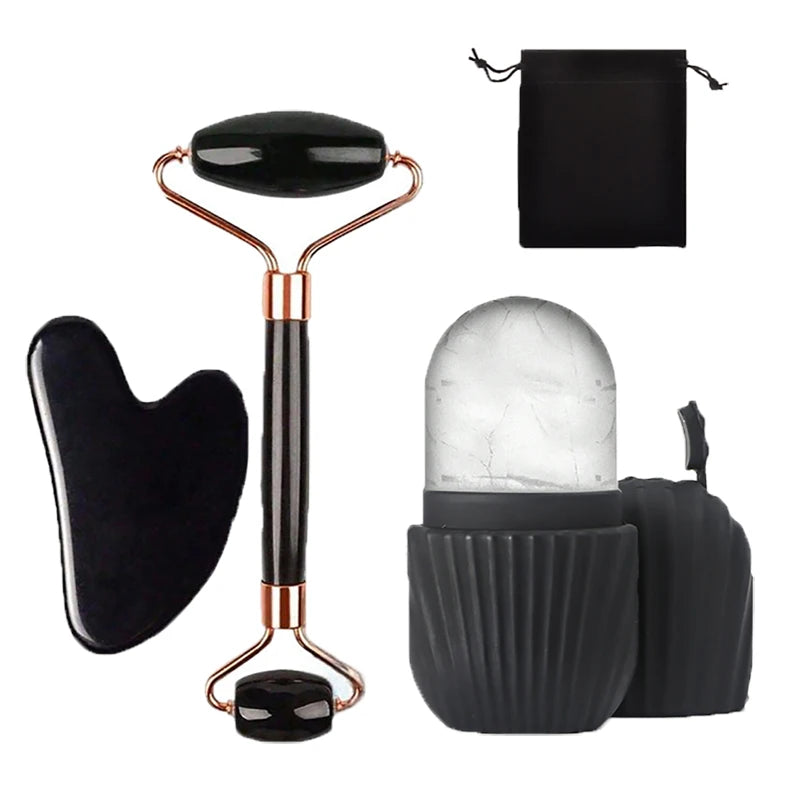 Set of facial massage tools including a roller, gua sha tool, and a small container with a roller inside on a white background.