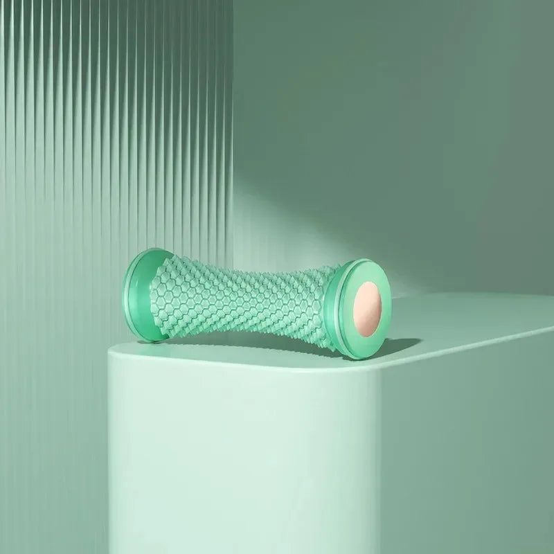 Green foam roller on a light green surface with a minimal background